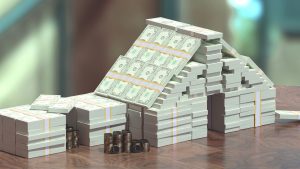 Money stacked into a house